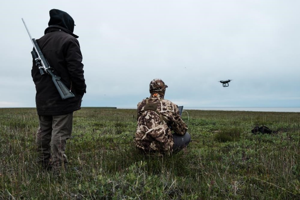 Field team operating a drone over remote tundra during a Canadian Arctic research mission.