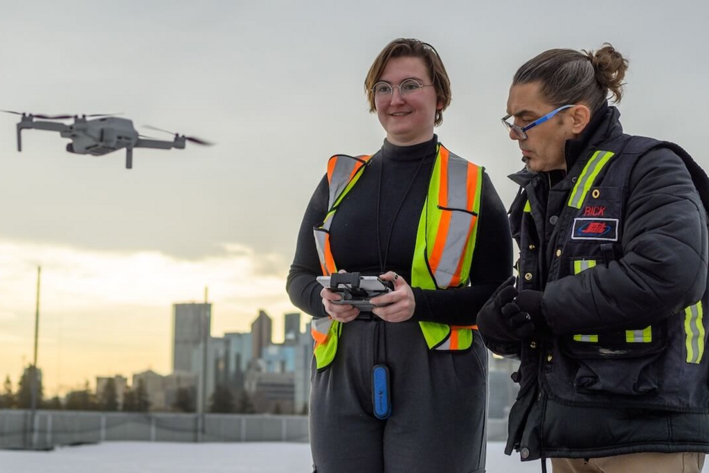 Canadian RPAS instructor guiding a student through a practical outdoor drone flight exercise.